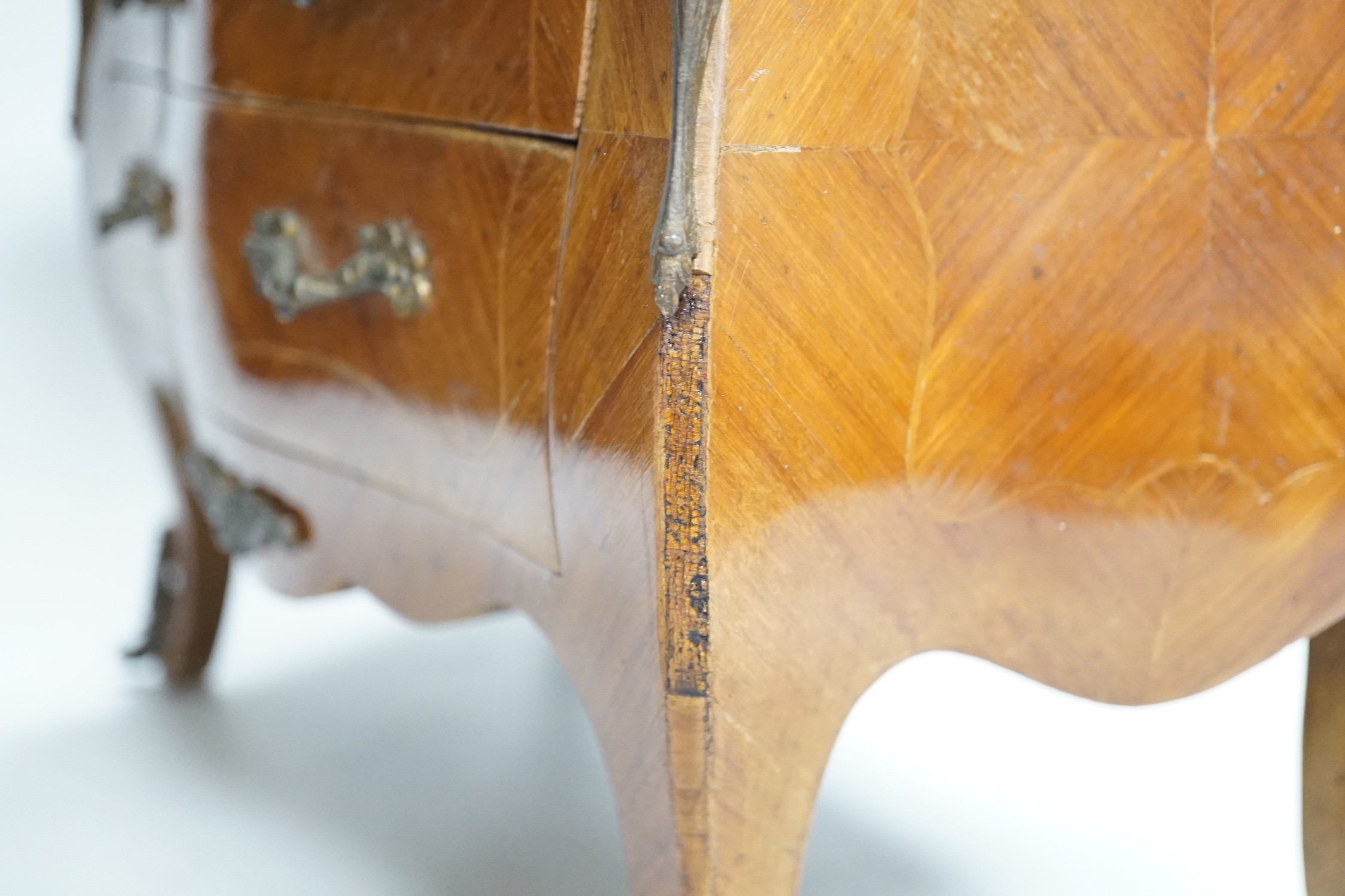 An Apprentice piece: Louis XV style miniature bowfronted French chest, with gilt mounts and pink and grey marble top. 27cm tall, 36cm wide, 17cm deep